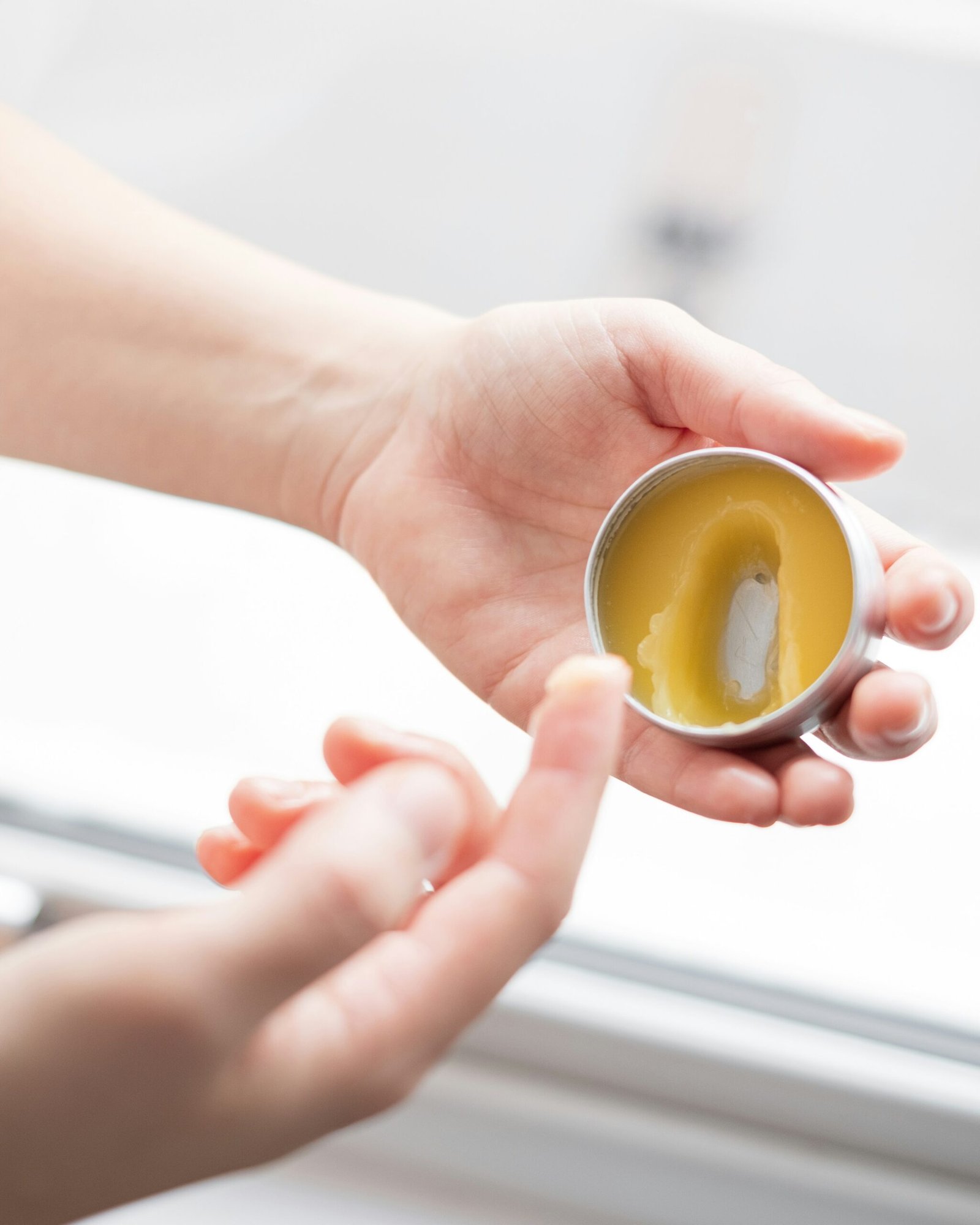 person holding yellow round ornament